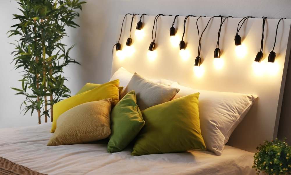 A Christmas fairy light flickering on the headboard